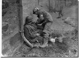 SC 202244 - Sgt. Schillcutt, a medical aid dresses a soldier's wounds wounds, March 9, 1945 - Pvt. H. Gasiewicz